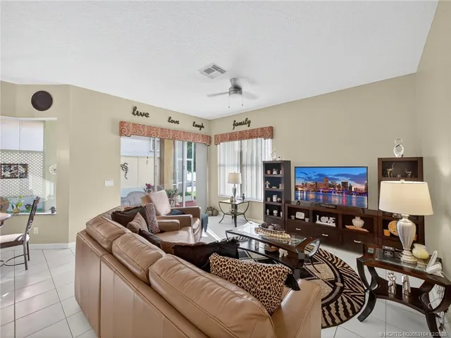 a living room with furniture and a lamp