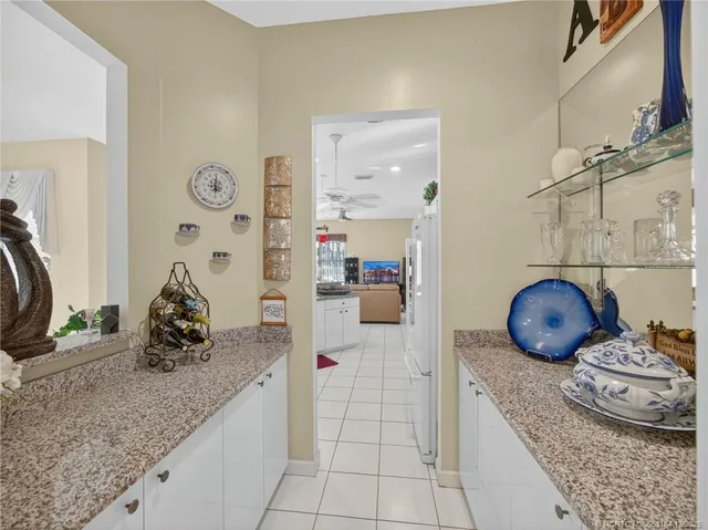 a kitchen with granite countertop a sink and cabinets