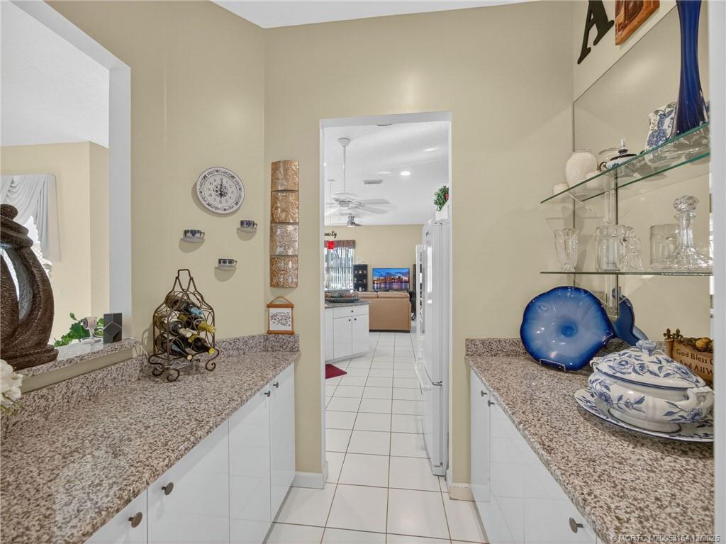 618 Southwest Lake Charles Circle Port St. Lucie, FL 34986 - Photo 10 of 29 a kitchen with granite countertop a sink and cabinets