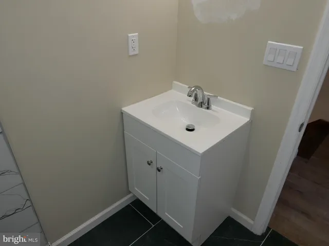 a bathroom with a sink and mirror