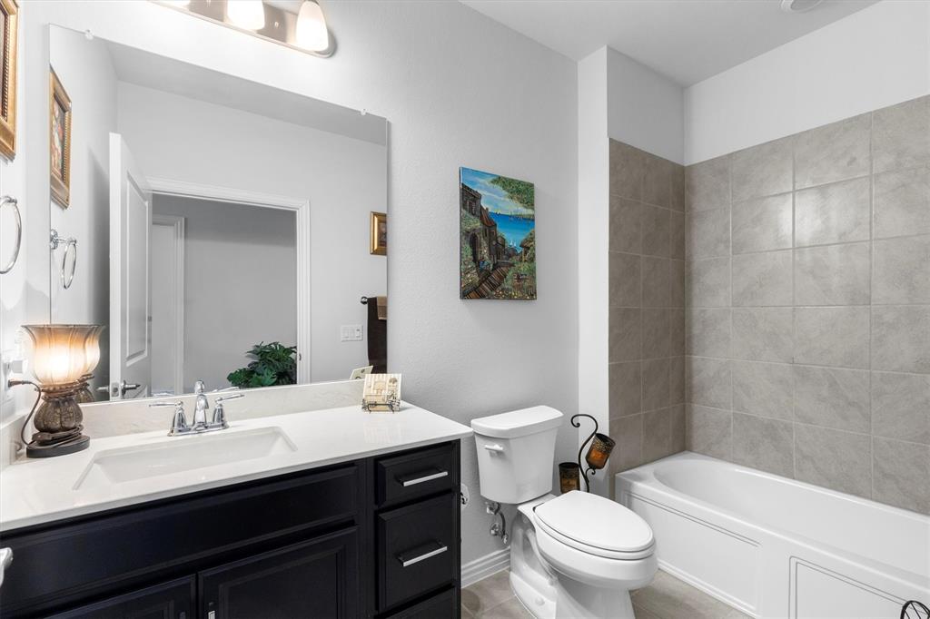 651 Watters Road, Unit 5205 Allen, TX 75013 - Photo 18 of 31 a bathroom with a sink a toilet a large mirror and shower