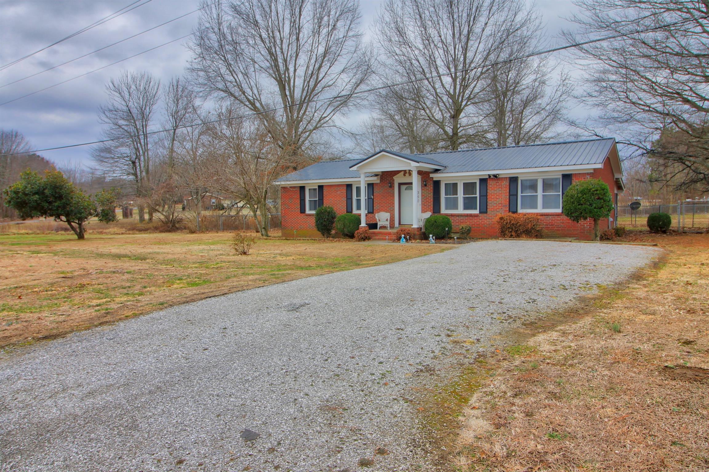 350 Jim Courtney Road Portland, TN 37148 - Photo 1 of 16 a front view of a residential houses with yard and trees