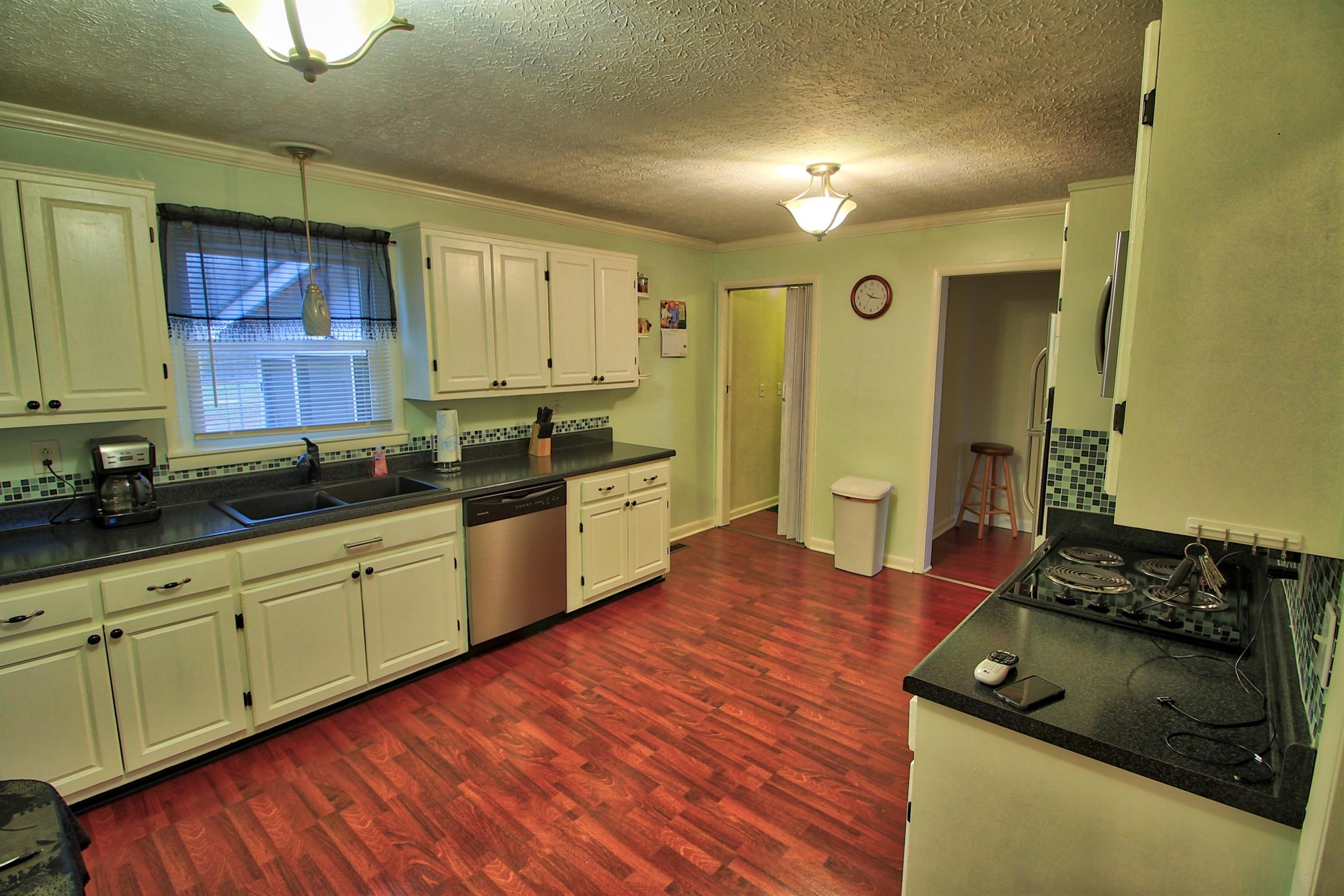 350 Jim Courtney Road Portland, TN 37148 - Photo 7 of 16 a kitchen with stainless steel appliances granite countertop a stove and cabinets