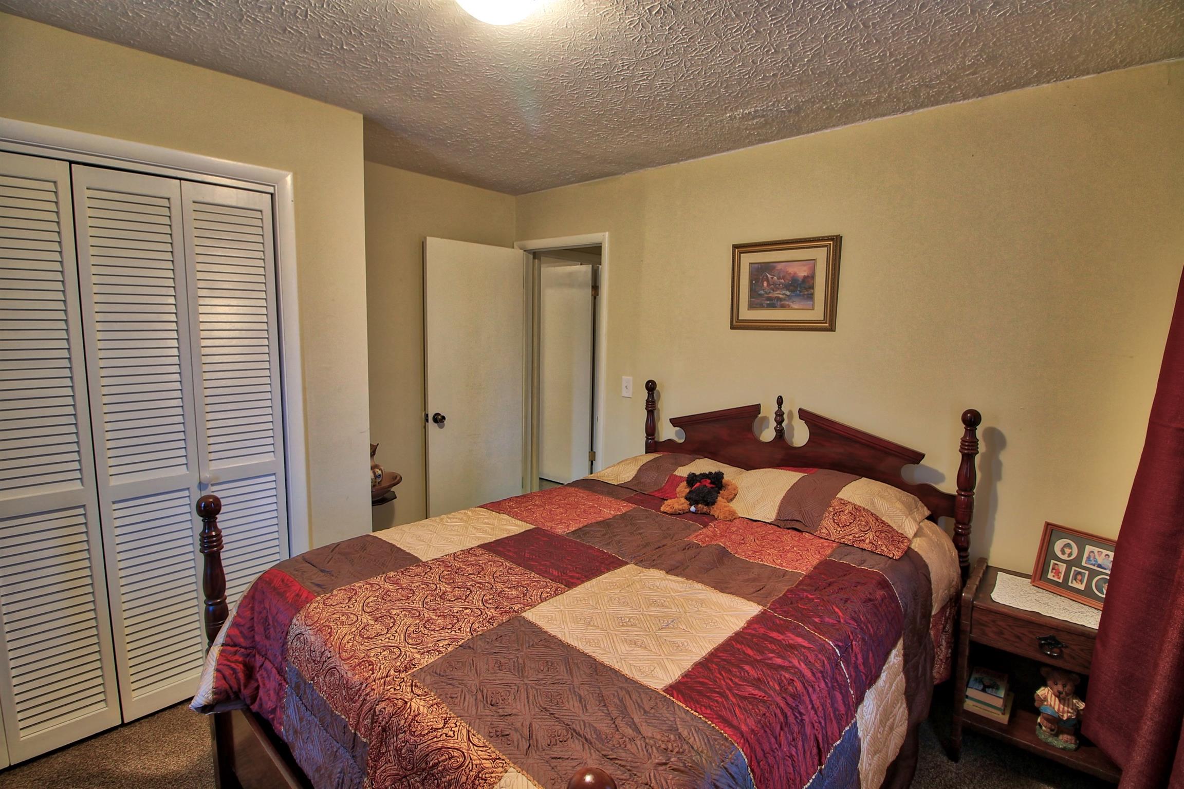 350 Jim Courtney Road Portland, TN 37148 - Photo 9 of 16 a bedroom with a bed and a closet