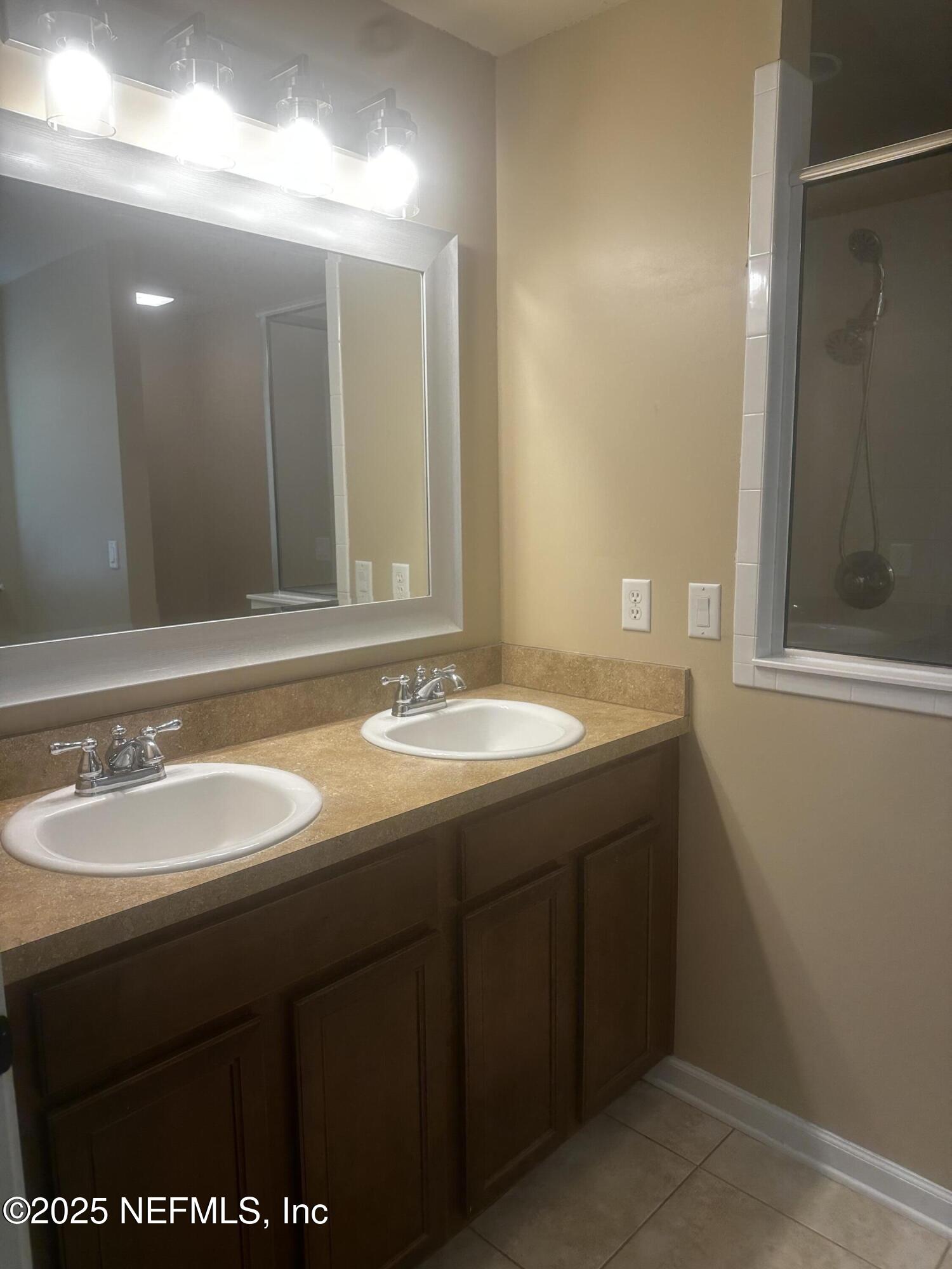 45157 Ingleham Circle Callahan, FL 32011 - Photo 23 of 48 a bathroom with a sink and a mirror