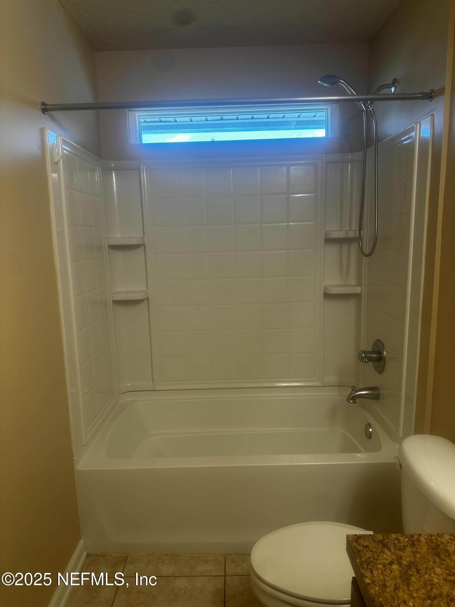 45157 Ingleham Circle Callahan, FL 32011 - Photo 38 of 48 a bathroom with a bathtub and a shower