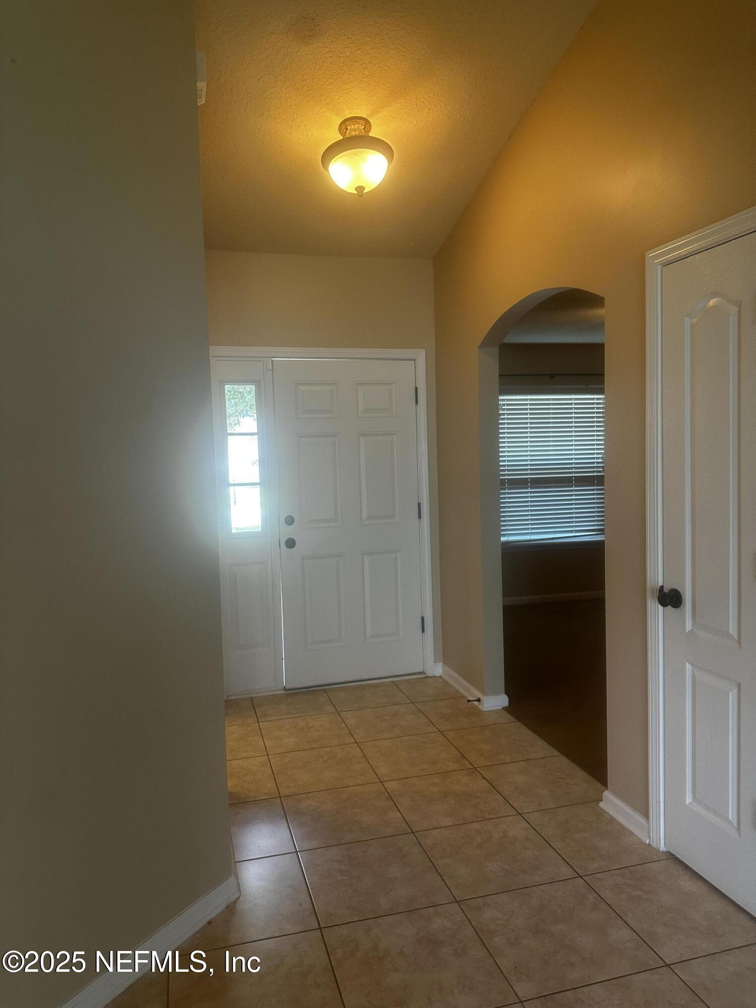45157 Ingleham Circle Callahan, FL 32011 - Photo 44 of 48 a view of a hallway with wooden shelves