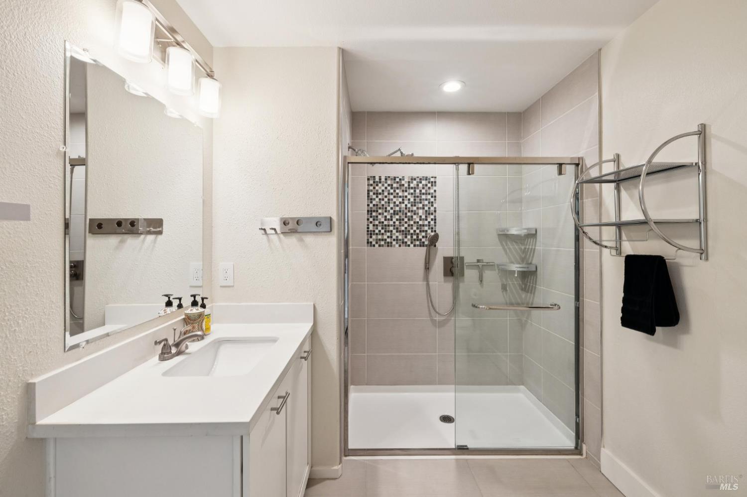 2672 Franz Kafka Avenue Santa Rosa, CA 95404 - Photo 17 of 25 a bathroom with a shower sink vanity and mirror
