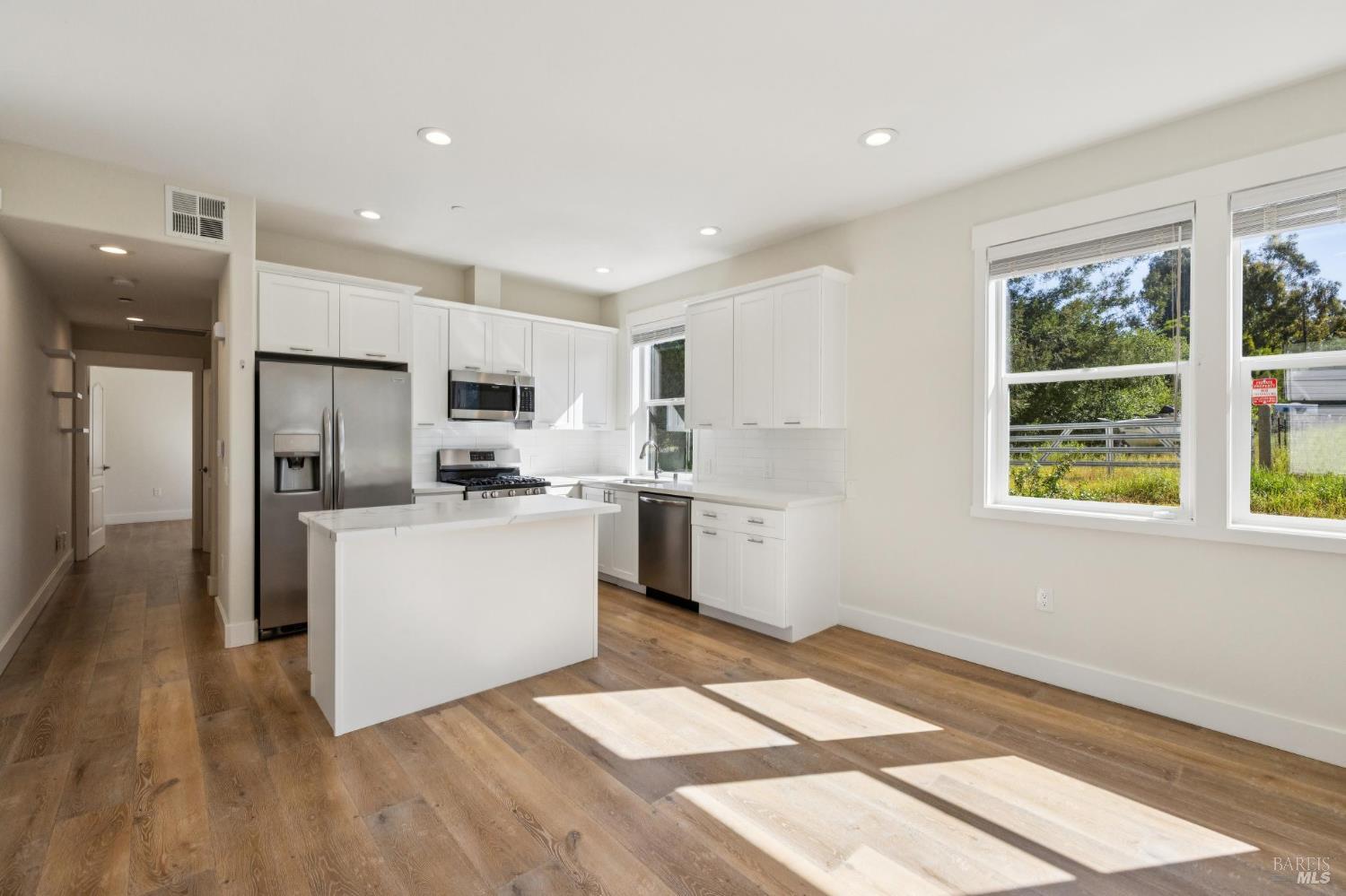 2672 Franz Kafka Avenue Santa Rosa, CA 95404 - Photo 4 of 25 a kitchen with white cabinets and appliances