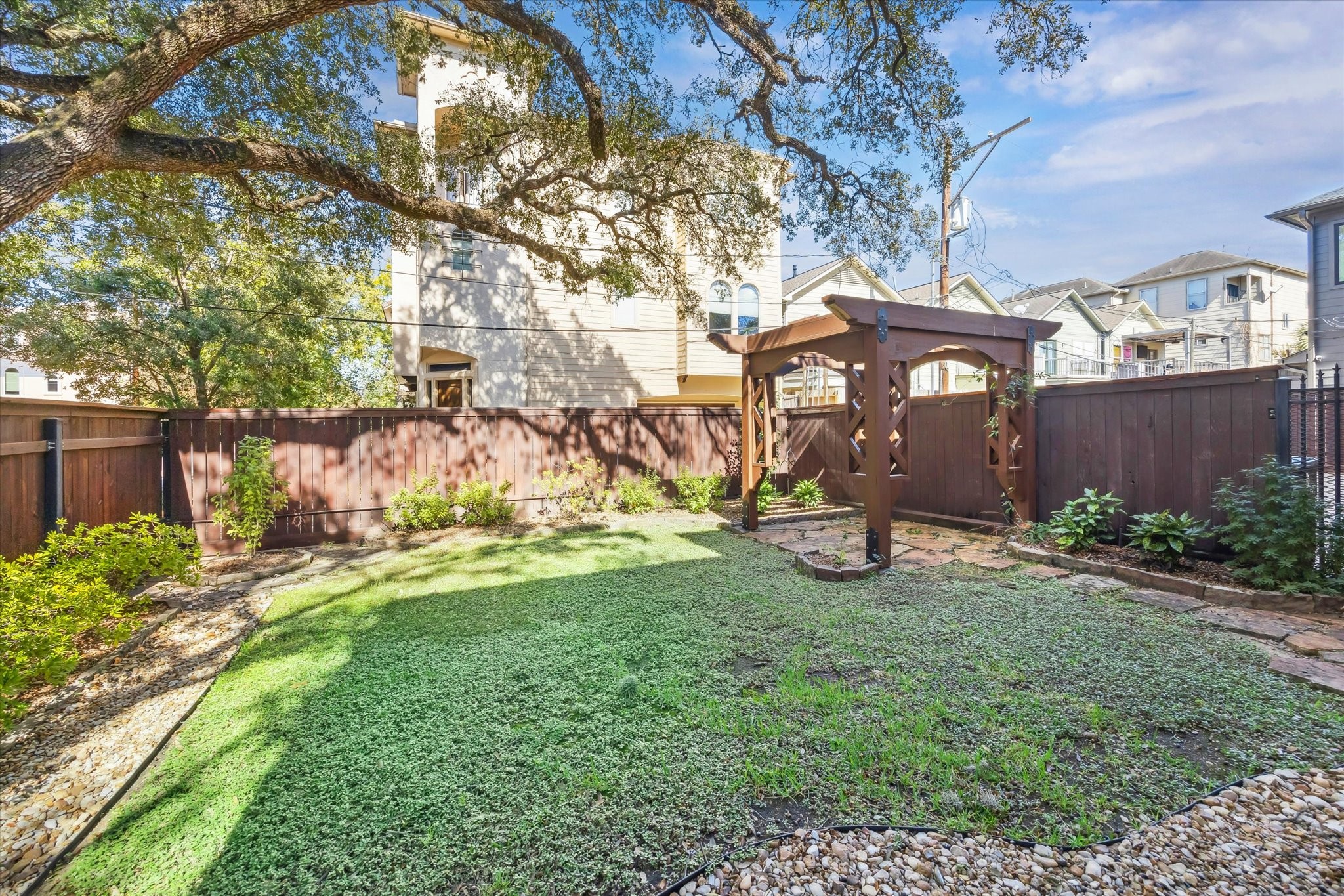 4320 Dickson Street Houston, TX 77007 - Photo 17 of 47 a view of a yard with plants and a bench