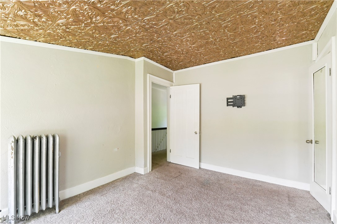 1584 Rydalmount Road Cleveland Heights, OH 44118 - Photo 30 of 36 Carpeted bedroom featuring radiator, an ornate ceiling, crown molding, and baseboards