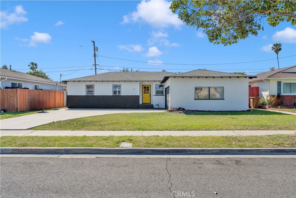 a front view of a house with a garden and yard