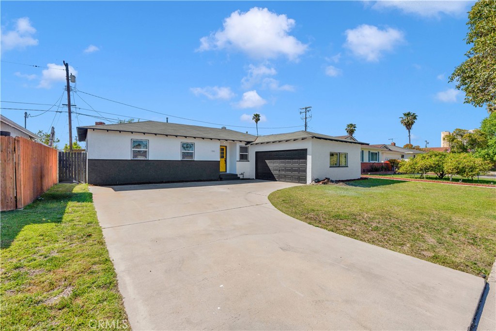 1007 North Mohawk Avenue Anaheim, CA 92801 - Photo 2 of 31 a front view of a house with a yard