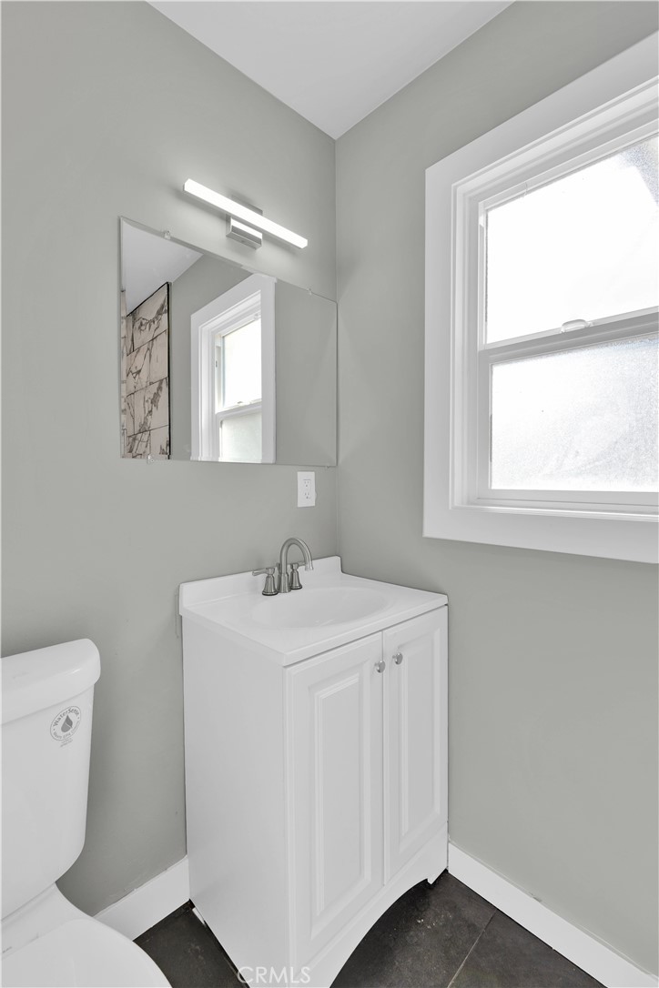 1007 North Mohawk Avenue Anaheim, CA 92801 - Photo 21 of 31 a bathroom with a toilet sink vanity and mirror