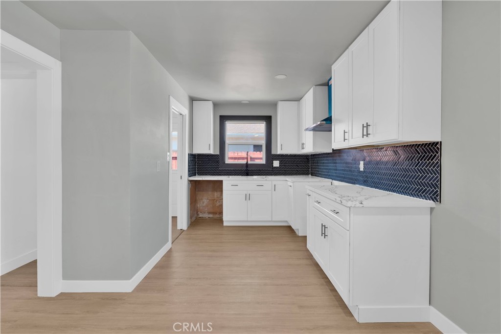 1007 North Mohawk Avenue Anaheim, CA 92801 - Photo 6 of 31 a kitchen with granite countertop white cabinets and white appliances