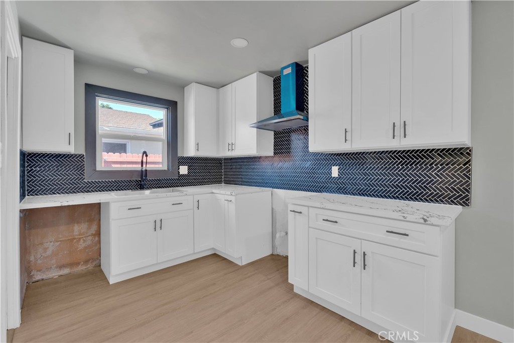 1007 North Mohawk Avenue Anaheim, CA 92801 - Photo 7 of 31 a kitchen with granite countertop white cabinets white appliances and granite countertops