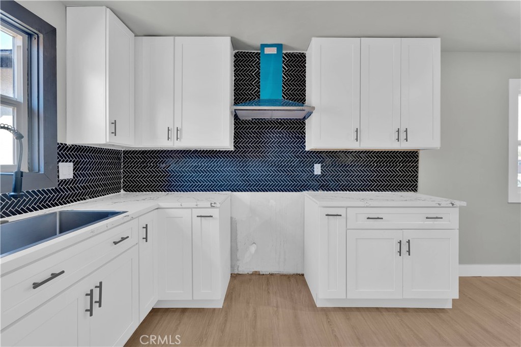 1007 North Mohawk Avenue Anaheim, CA 92801 - Photo 9 of 31 a kitchen with white cabinets and sink