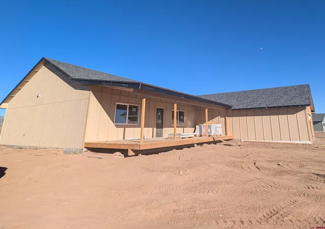 a view of a house with a wooden fence
