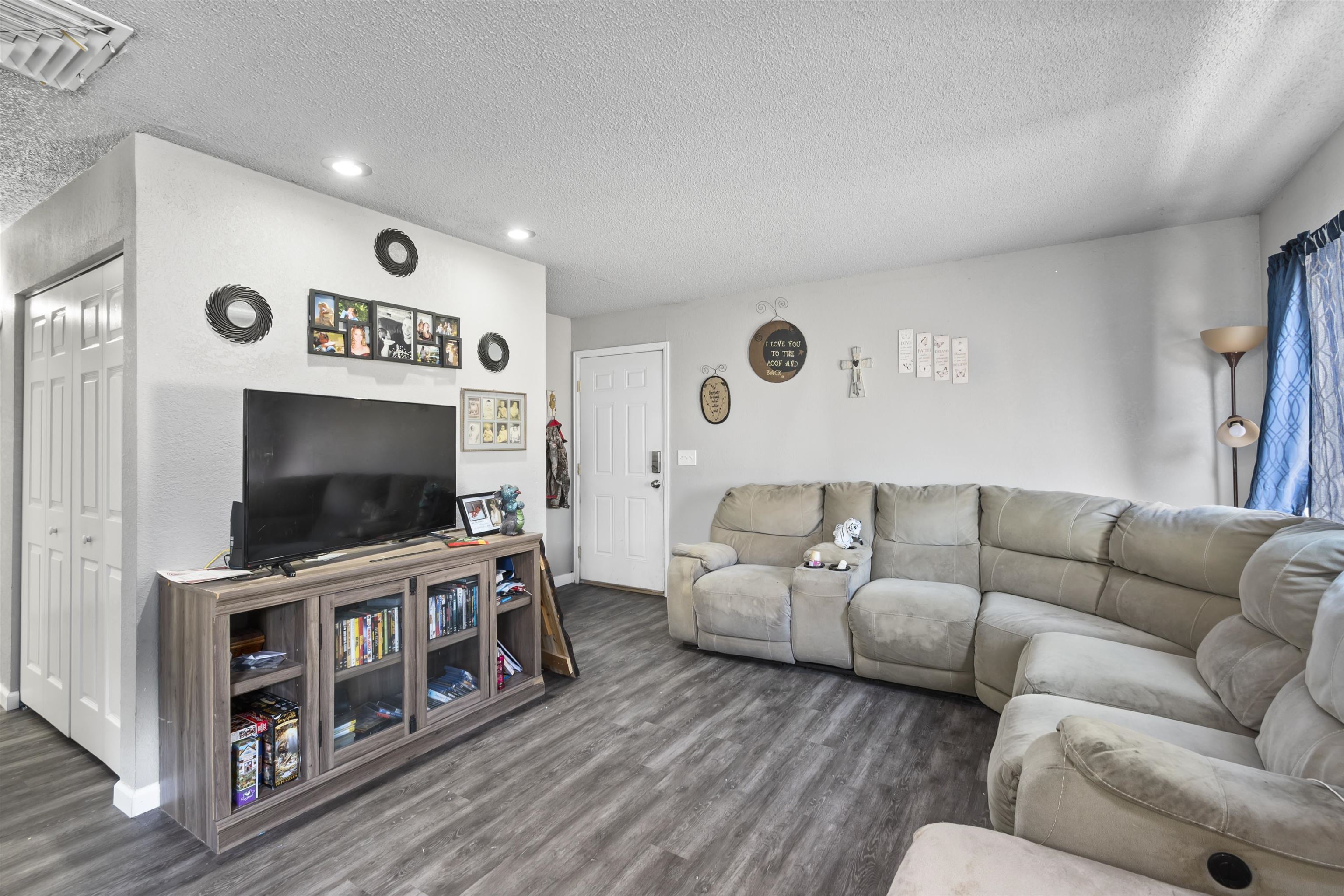 557 North Sparn Street Grand Junction, CO 81501 - Photo 13 of 31 a living room with furniture and a flat screen tv
