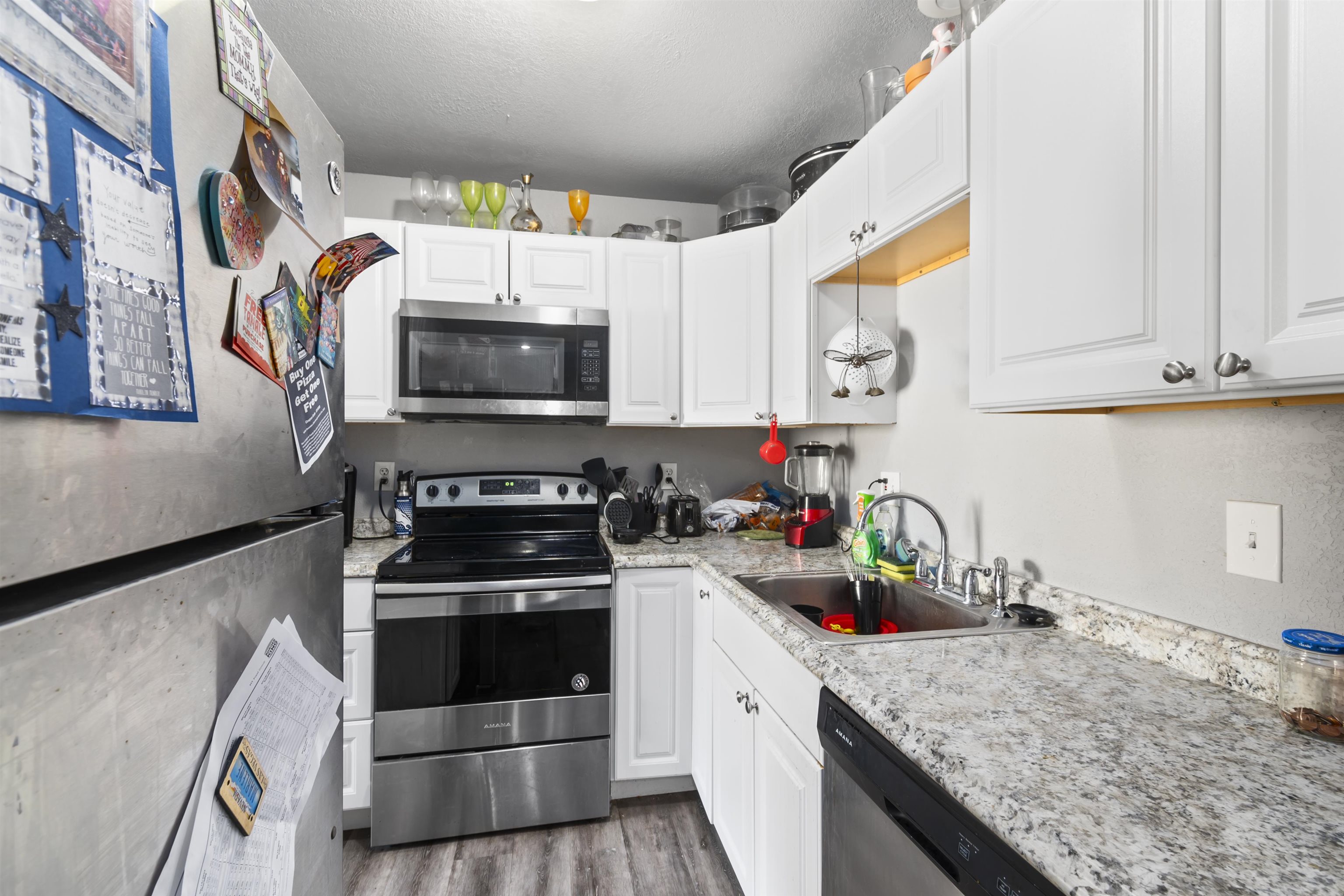 557 North Sparn Street Grand Junction, CO 81501 - Photo 14 of 31 a kitchen with stainless steel appliances granite countertop a stove a sink and a microwave