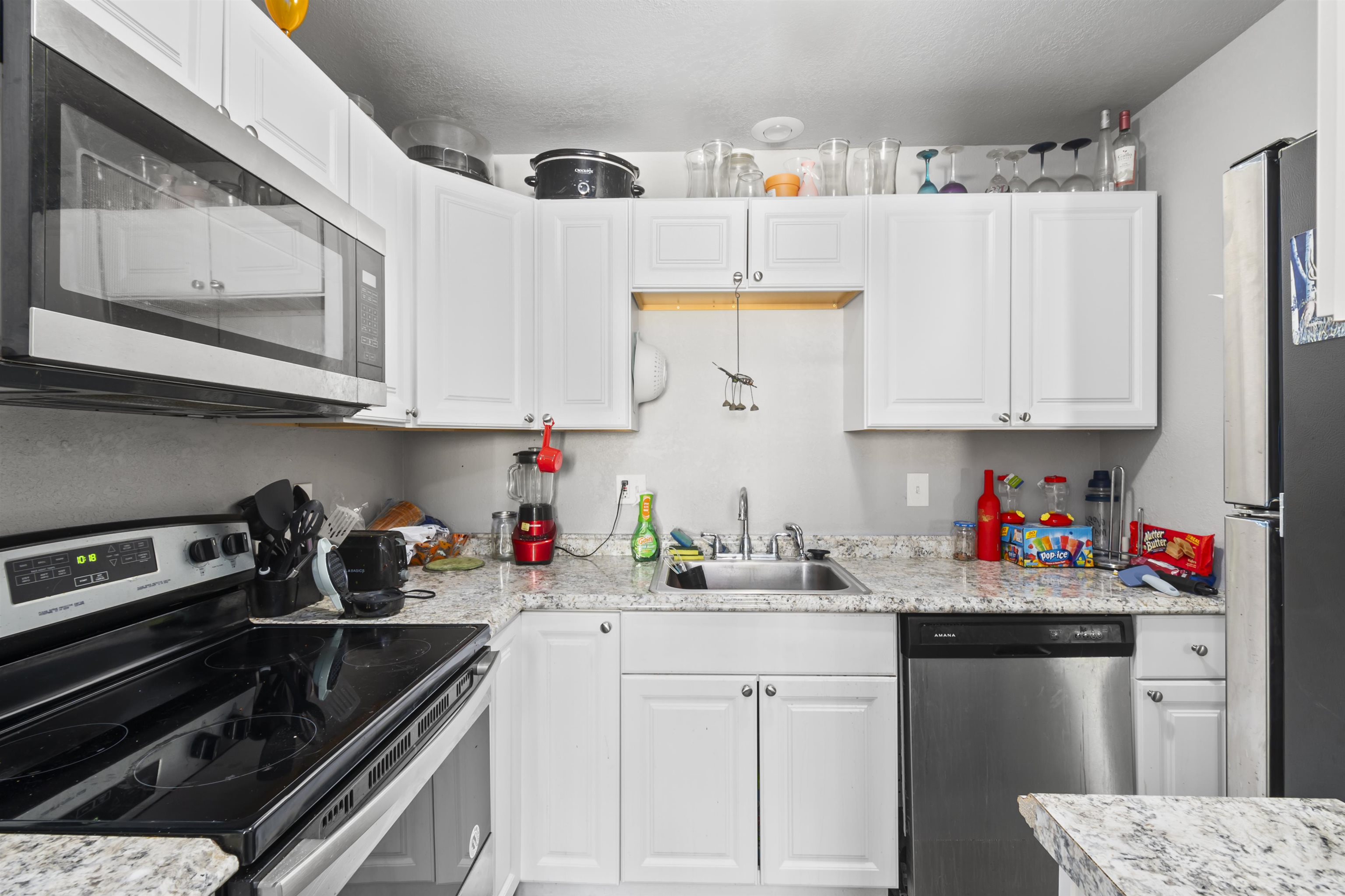 557 North Sparn Street Grand Junction, CO 81501 - Photo 15 of 31 a kitchen with stainless steel appliances granite countertop a sink dishwasher stove and cabinets