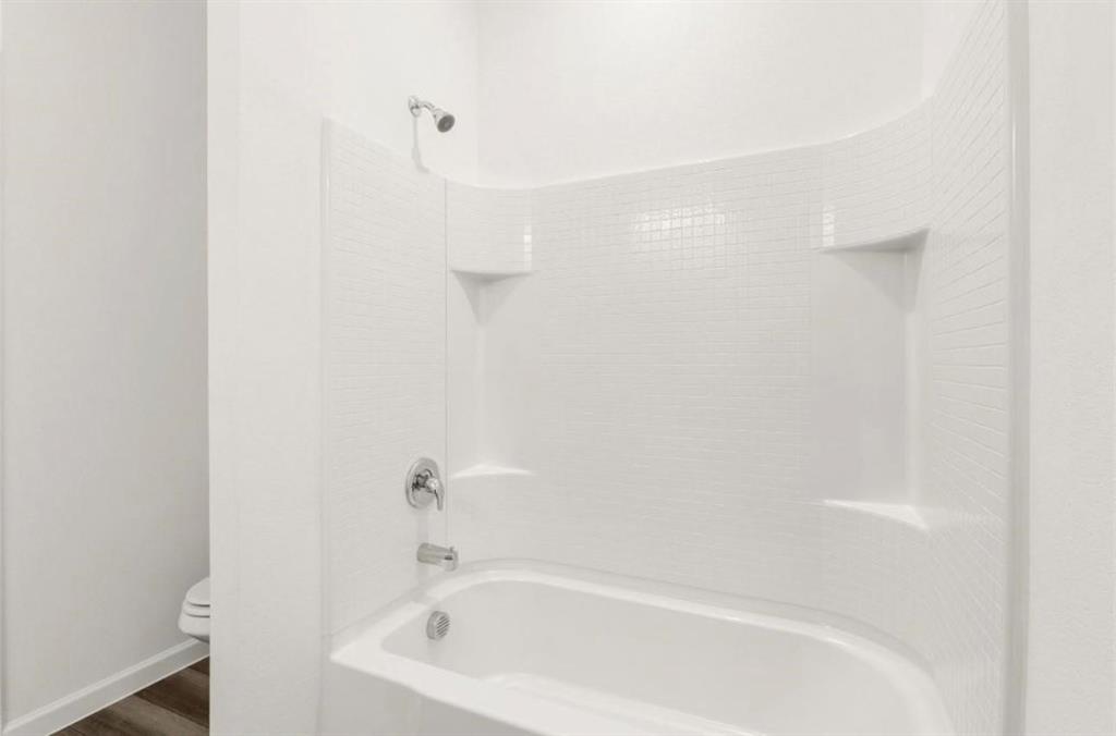 10308 Holy Cross Lane Crowley, TX 76036 - Photo 23 of 27 a white bath tub sitting next to a white sink
