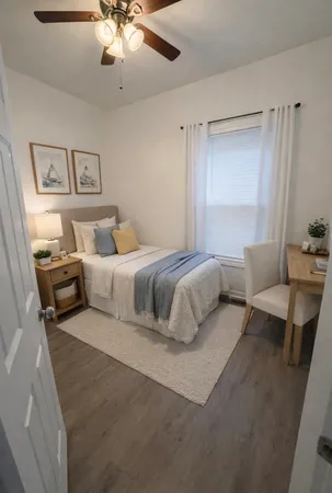 a bedroom with a bed and wooden floor
