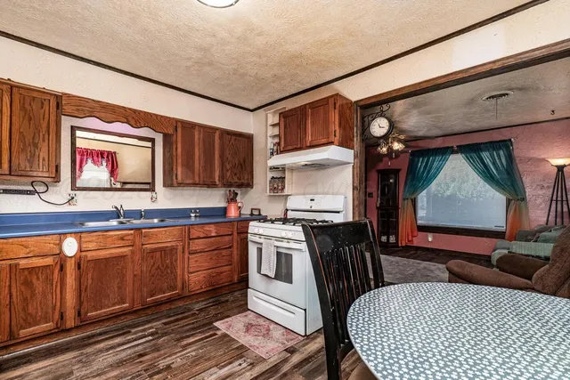 a kitchen with a stove a sink and a microwave