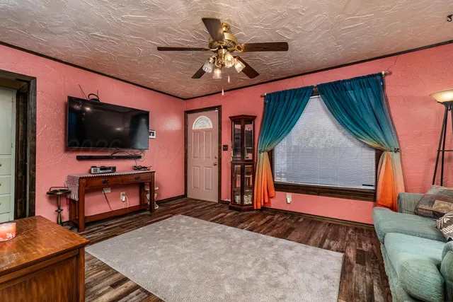 a living room with furniture and a flat screen tv