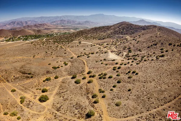 a view of a field with an ocean