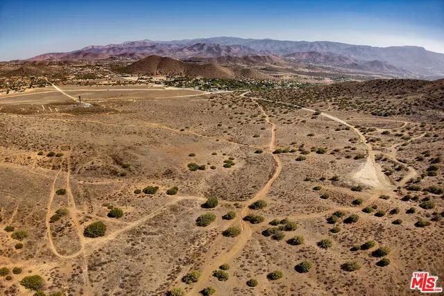 a view of a large mountains with mountains in the background