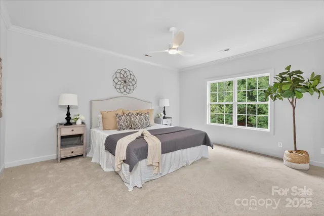 a spacious bedroom with a bed and a window