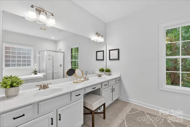 a bathroom with a sink double vanity and a mirror