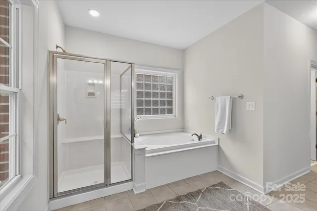 a bathroom with a bathtub and a shower