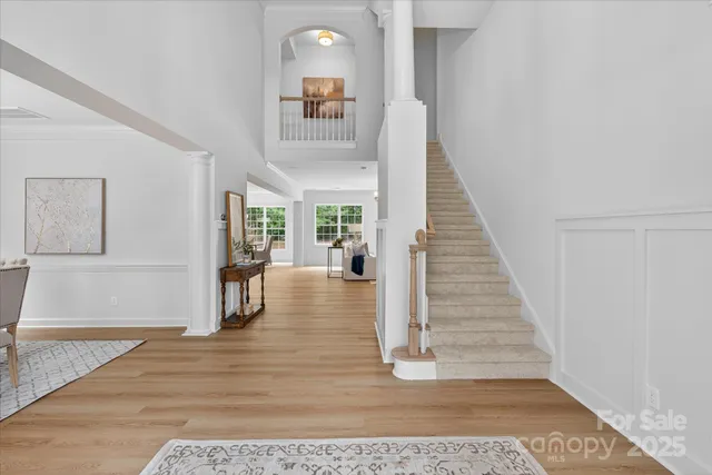 a view of entryway and hall with wooden floor