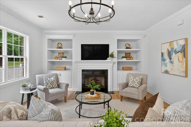 a kitchen with stainless steel appliances granite countertop a stove top oven a sink dishwasher and white cabinets with wooden floor