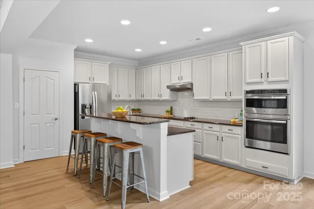 a kitchen with cabinets and stainless steel appliances