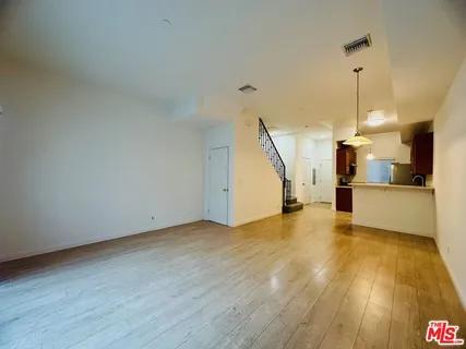a view of a kitchen with a sink and wooden floor