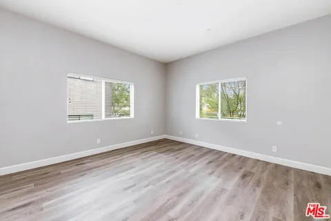 a view of a kitchen with furniture and wooden floor