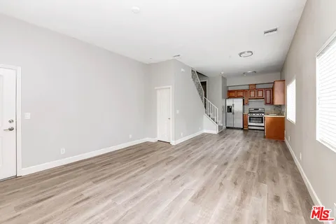 a view of kitchen with sink and wooden floor