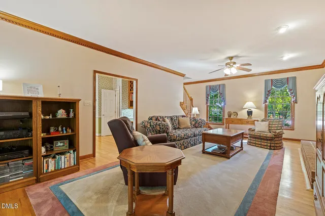 a living room with furniture and a book shelf