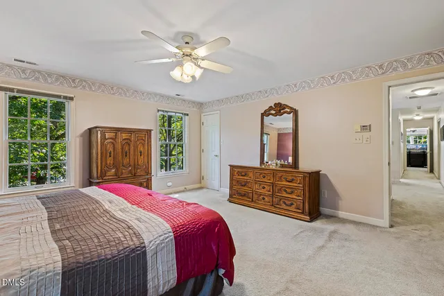 a bedroom with a bed dresser and a window