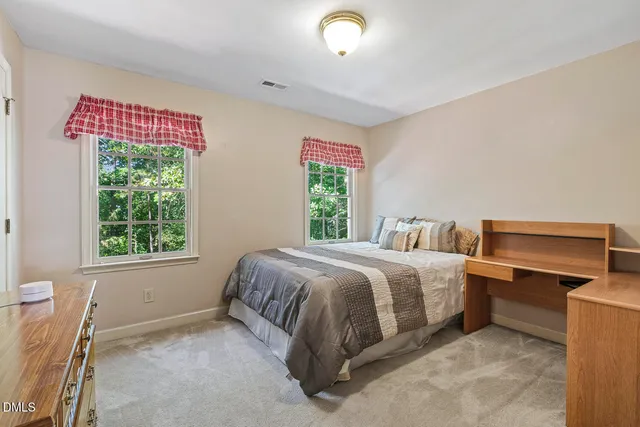 a spacious bedroom with a bed and a window