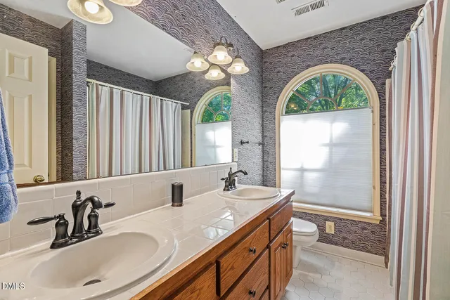 a bathroom with a double vanity sink and a mirror