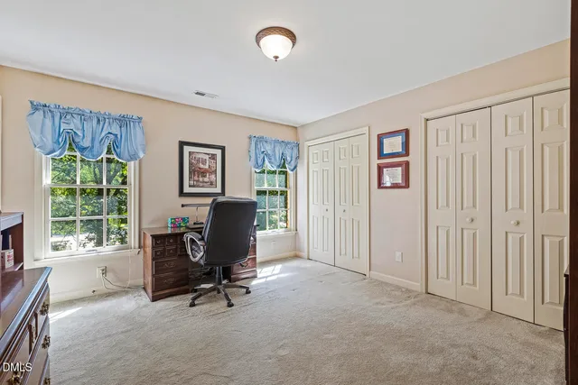 a view of a livingroom with workspace and a window
