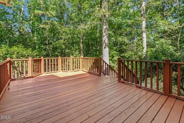 a view of deck with wooden floor and fence