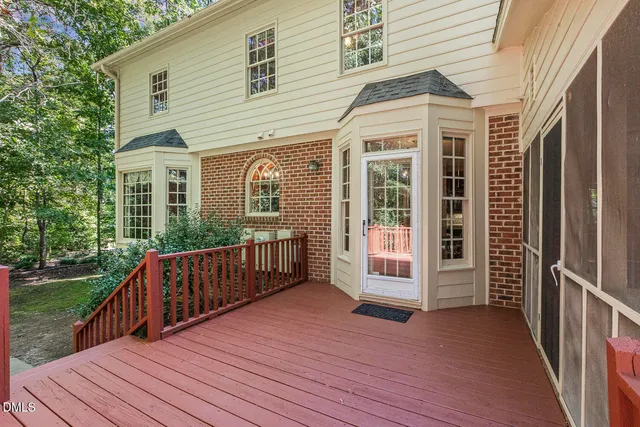 a view of backyard with deck and wooden floor