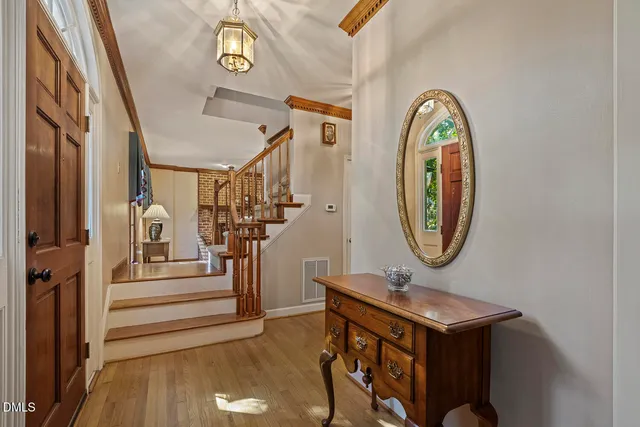 a view of a hallway with entryway wooden floor and front door