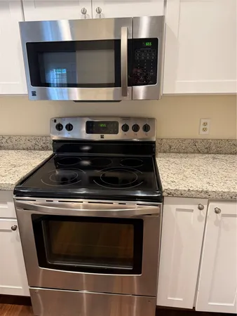 an empty room with wooden floor and a bathroom
