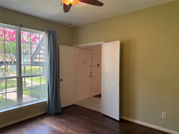 a view of a room with wooden floor